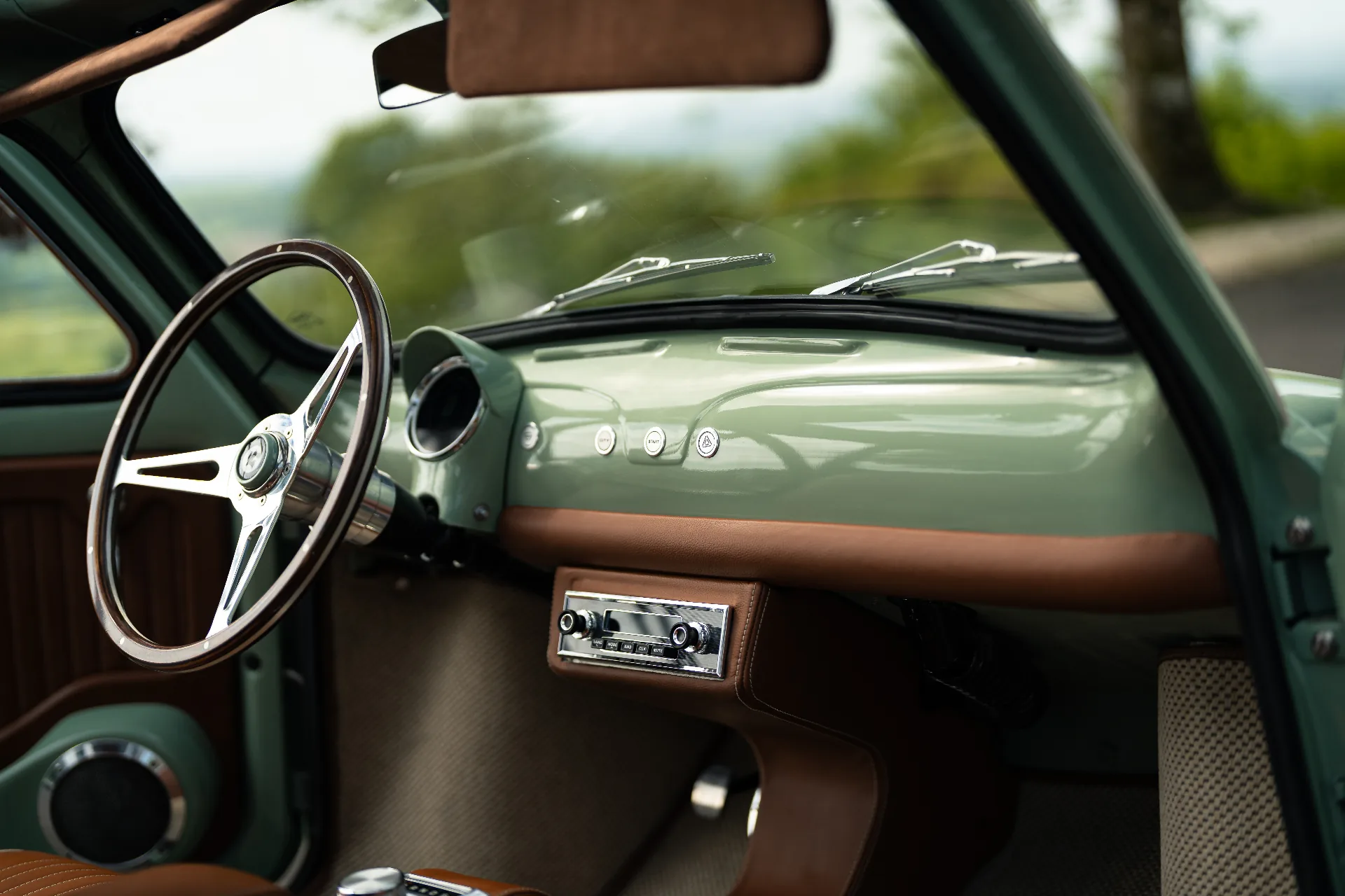 Mint dashboard with start button, chrome stereo and cognac leather trim