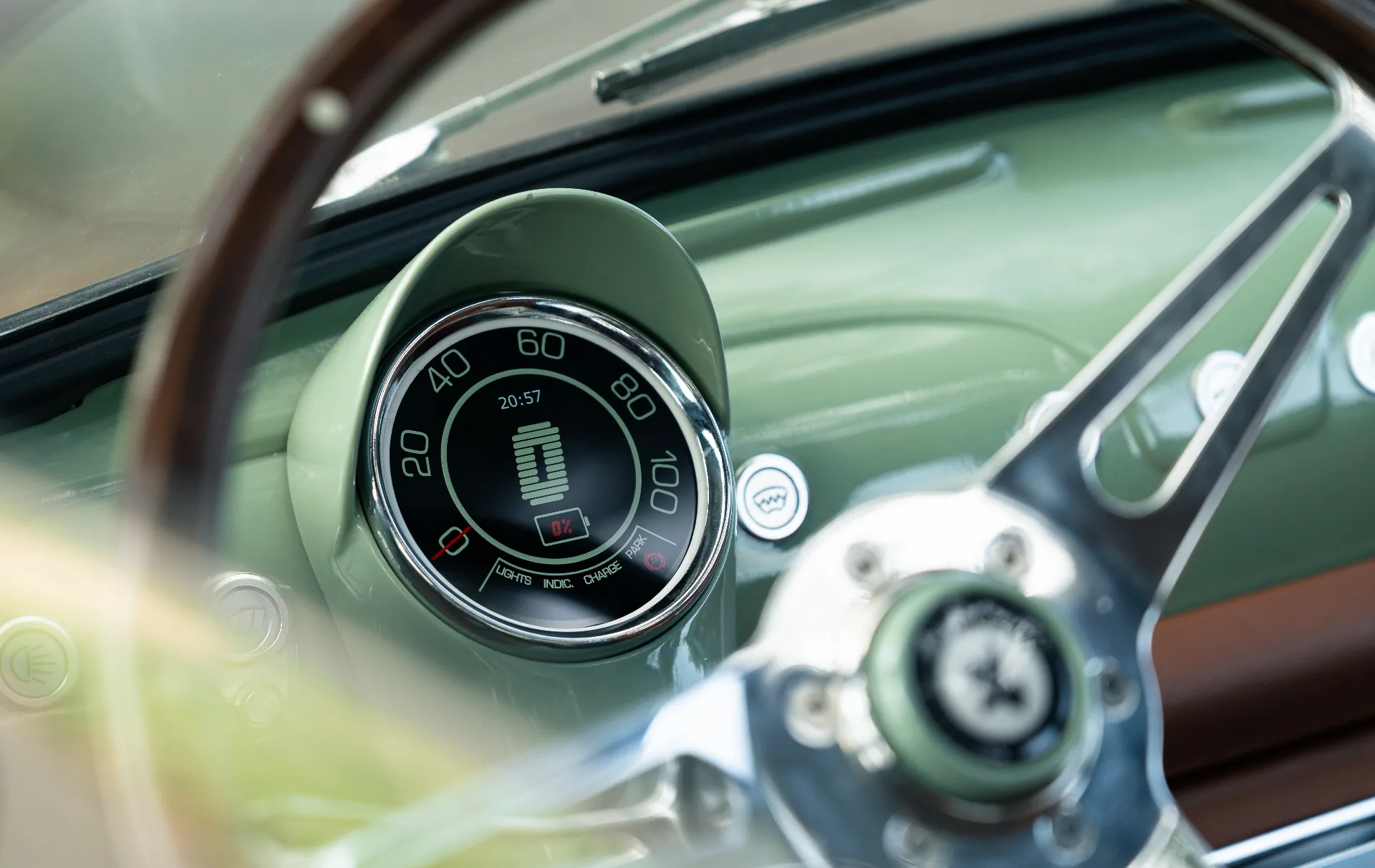Retro-modern digital gauge cluster framed by wooden steering wheel
